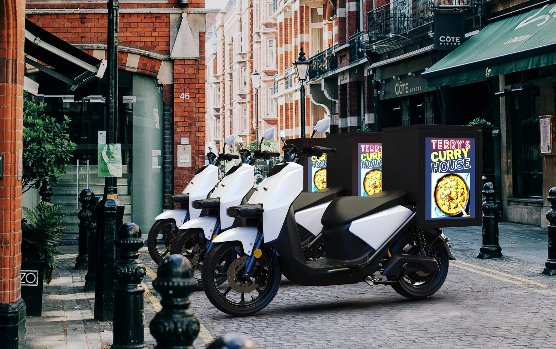 Line-up of Ad|MOTO UK scooters with Ad|BOX screens on a cobbled street